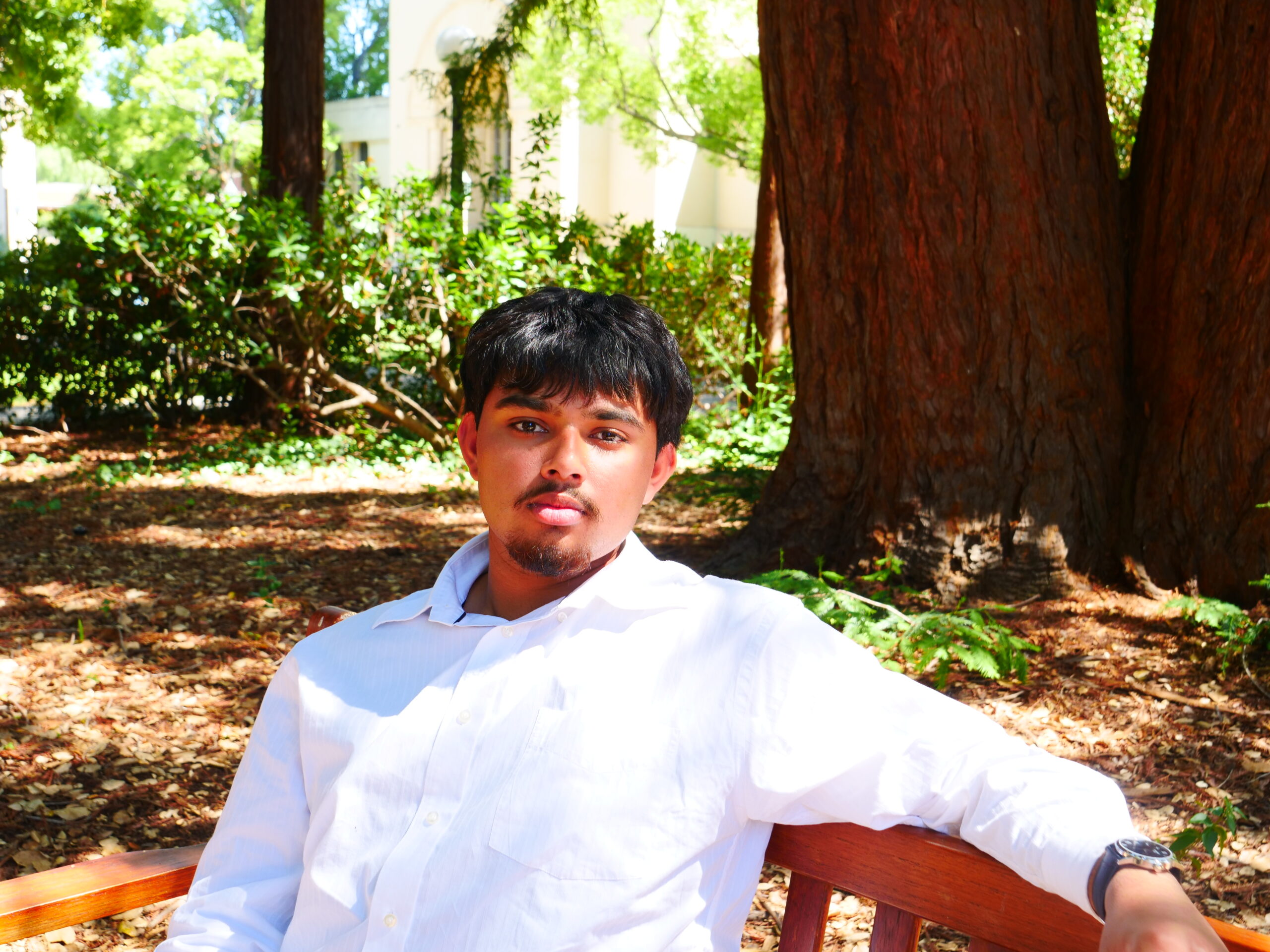 Aryav Dube sitting on bench, posing