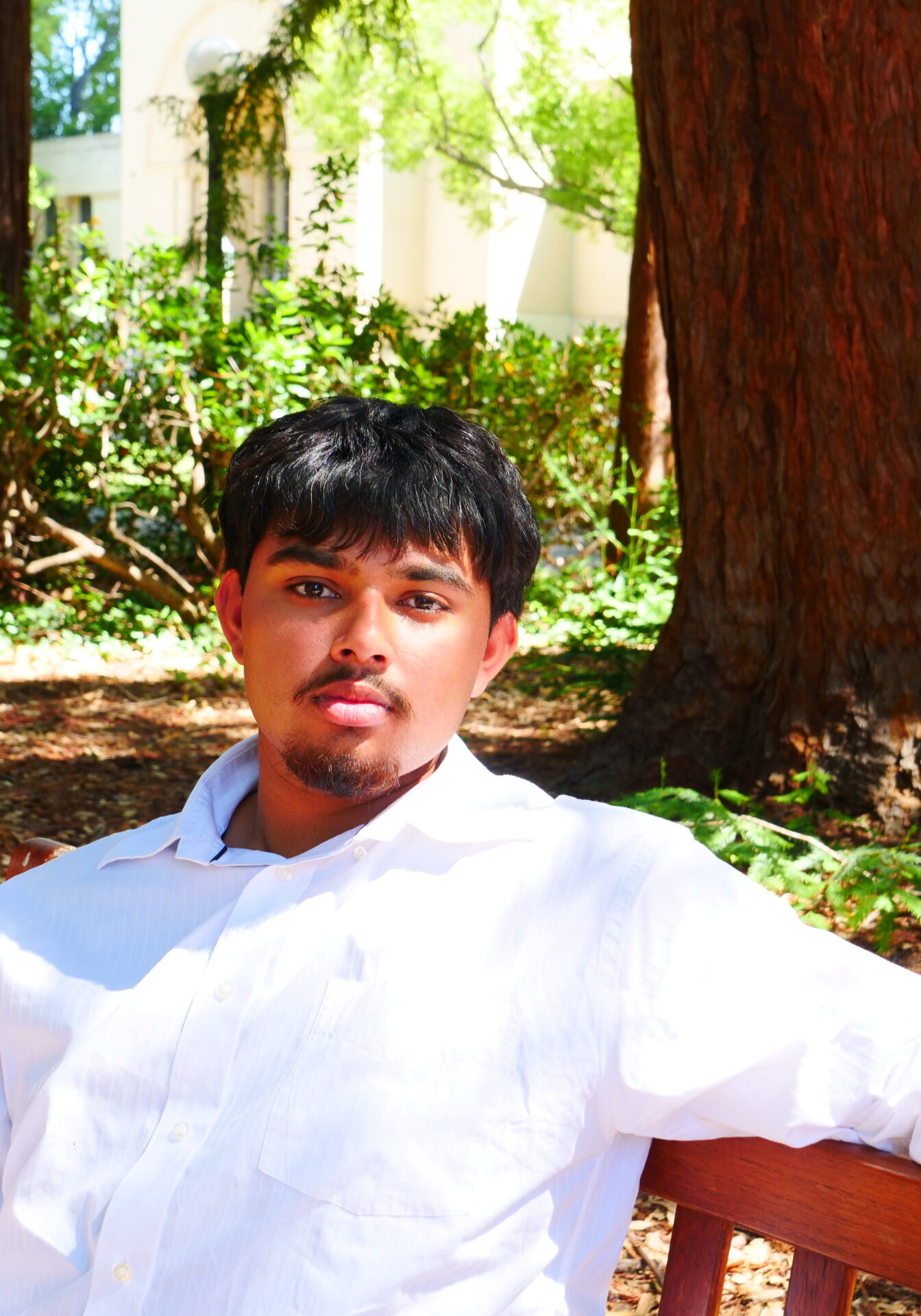 Aryav Dube sitting on bench, posing